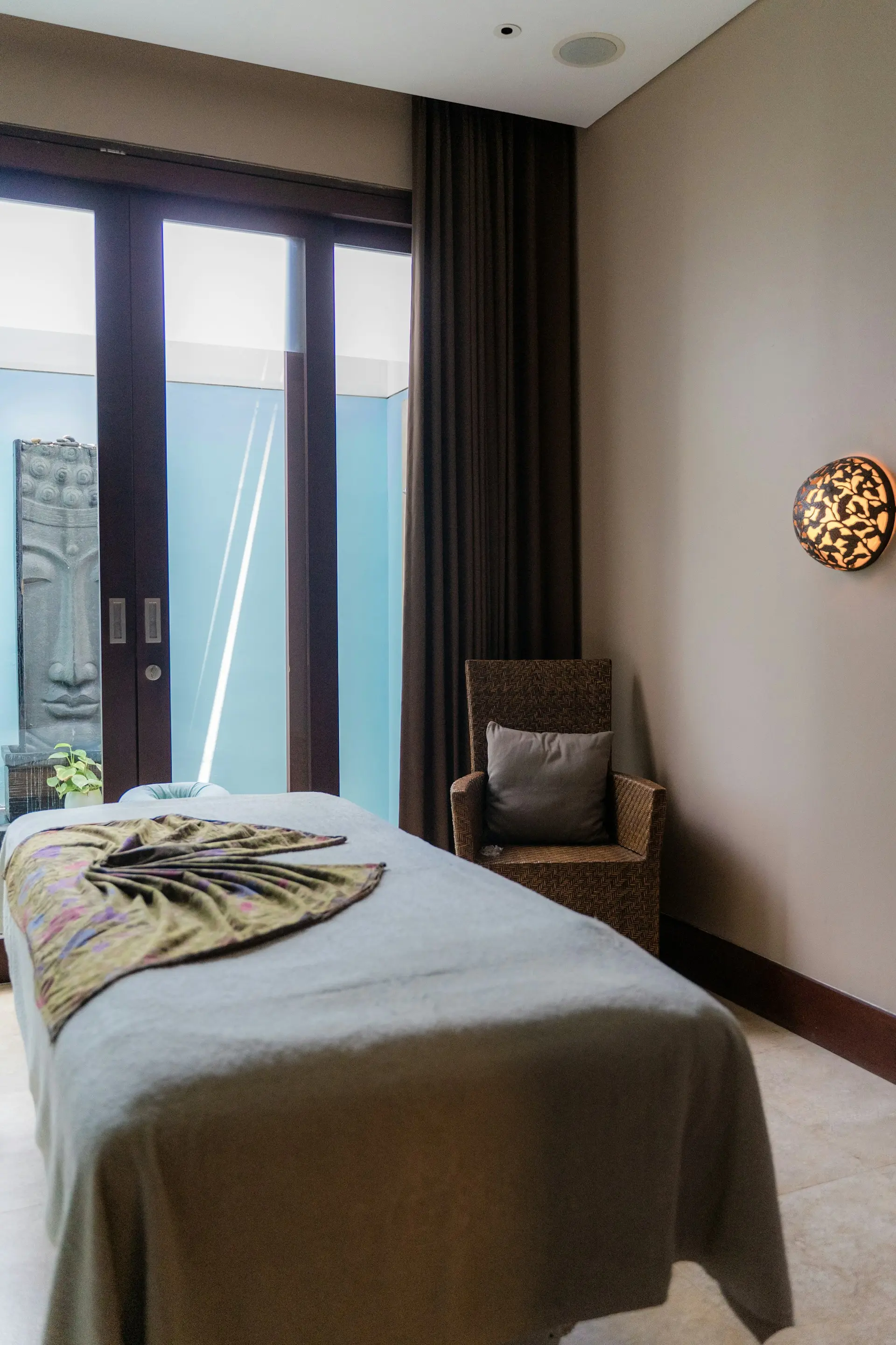 Softly lit spa treatment room with natural textures
